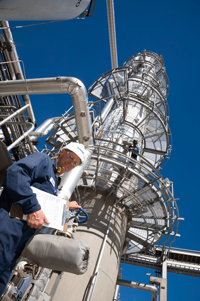 Suncor worker standing in front of tower